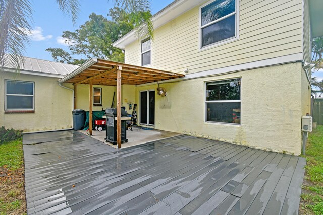 back of house with a patio area and a lawn