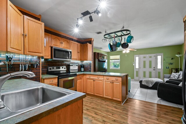 living room featuring ceiling fan, sink, rail lighting, and light tile patterned flooring