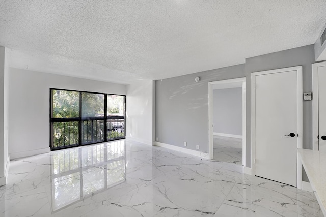 spare room with a textured ceiling