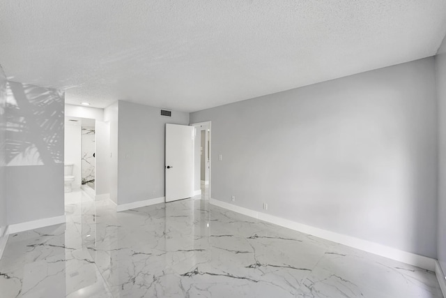 spare room featuring a textured ceiling