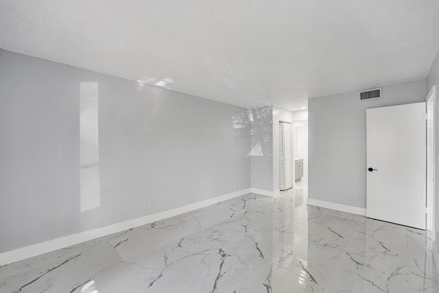 spare room featuring a textured ceiling