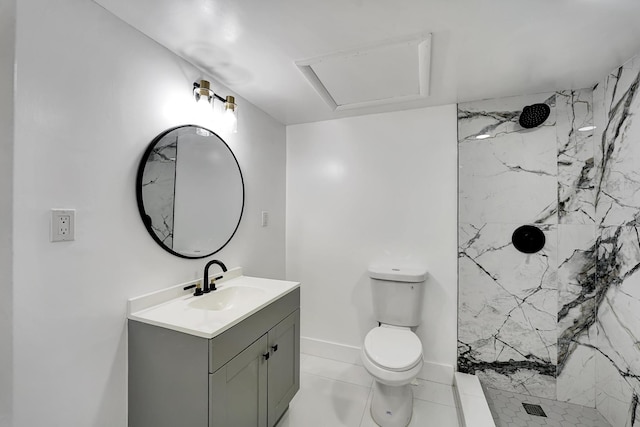 bathroom with tiled shower, vanity, and toilet