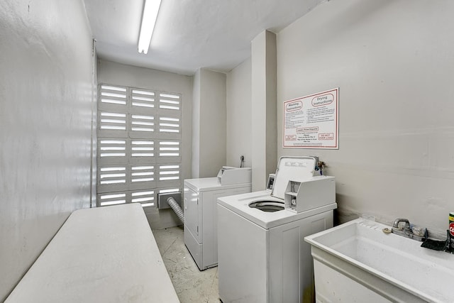 laundry room featuring sink and washer and dryer