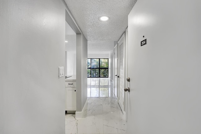 hallway featuring a textured ceiling