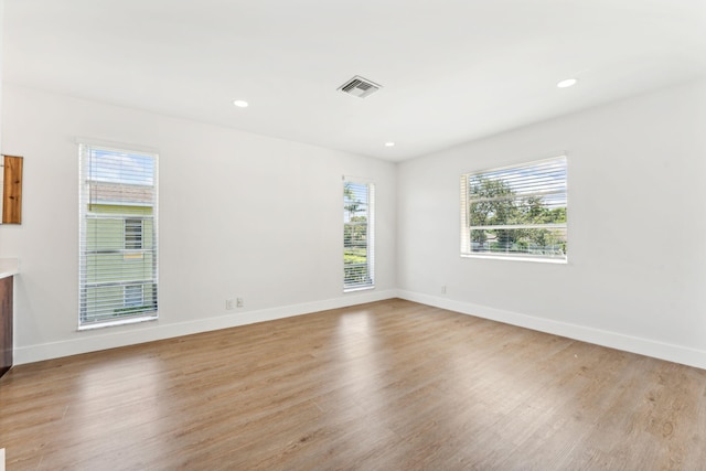 spare room with light hardwood / wood-style floors and a wealth of natural light