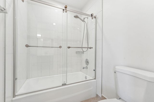 bathroom with shower / bath combination with glass door and toilet