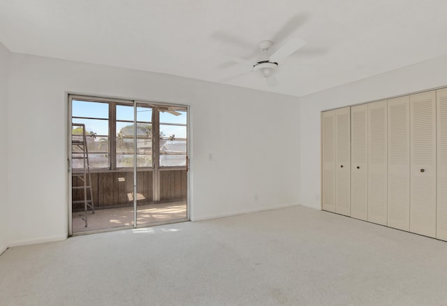 unfurnished bedroom with ceiling fan, a closet, access to exterior, and carpet