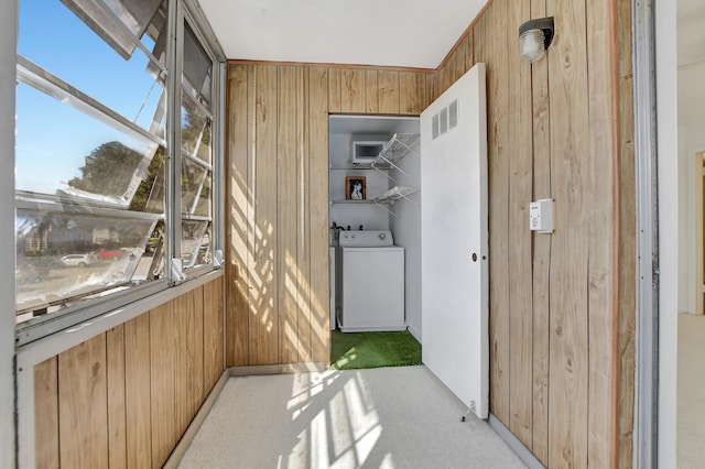 unfurnished sunroom featuring washer / clothes dryer