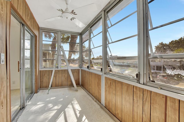 unfurnished sunroom featuring ceiling fan