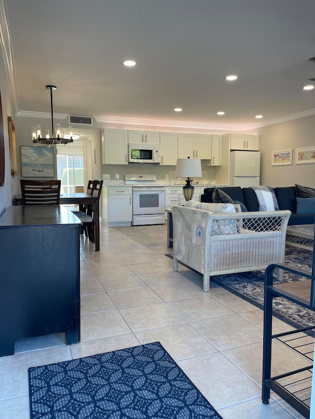 living room with light tile patterned flooring, ornamental molding, and a chandelier