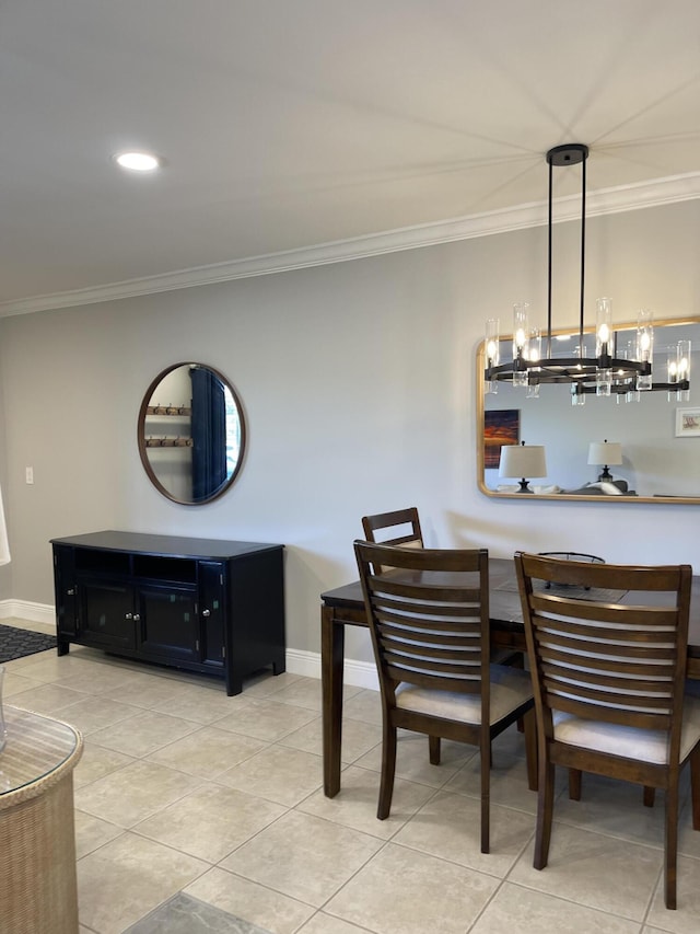 dining room with crown molding, light tile patterned floors, and baseboards