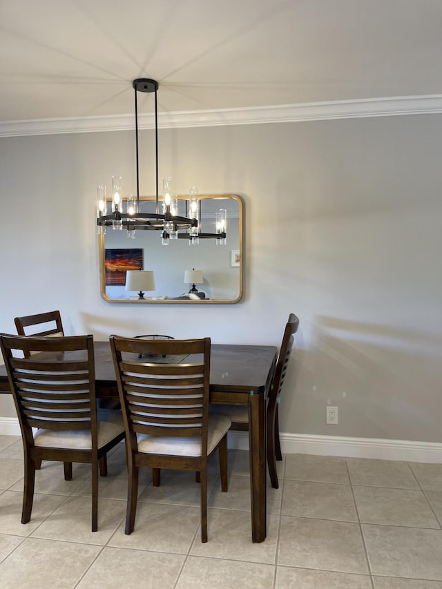 tiled dining area featuring baseboards, crown molding, and a notable chandelier