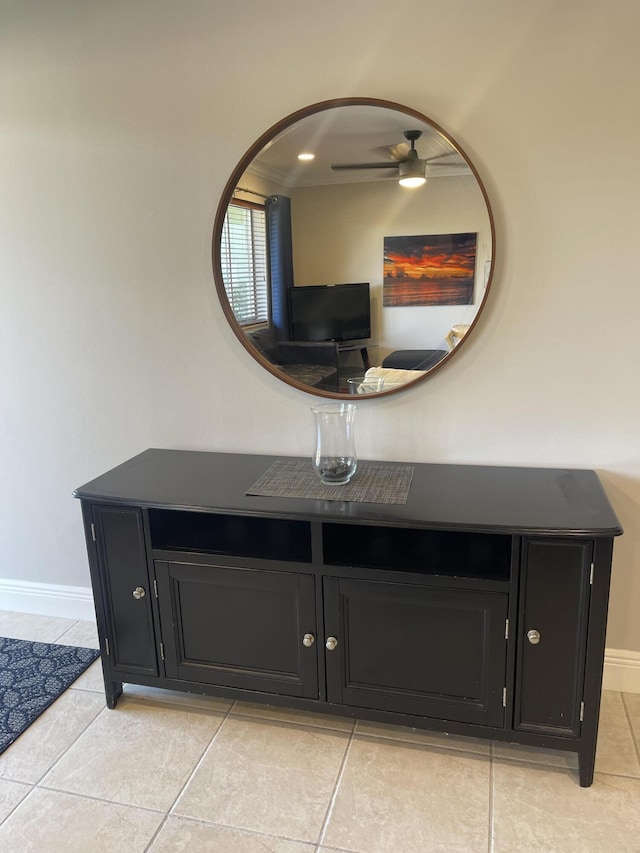 interior details with a ceiling fan and baseboards