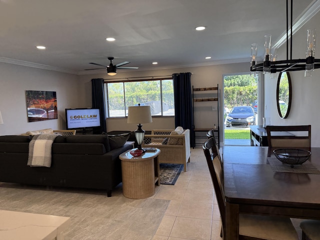 living area with crown molding, recessed lighting, ceiling fan with notable chandelier, and light tile patterned flooring