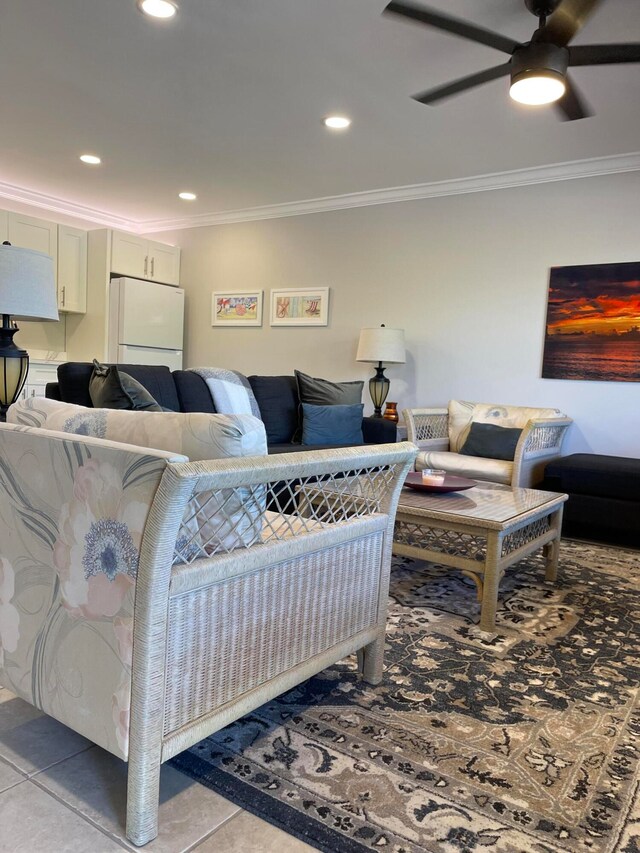 tiled living room with crown molding and ceiling fan