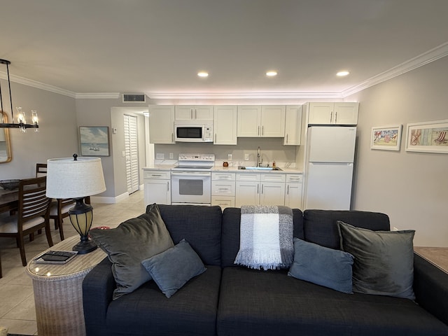 living area with an inviting chandelier, crown molding, visible vents, light tile patterned flooring, and baseboards