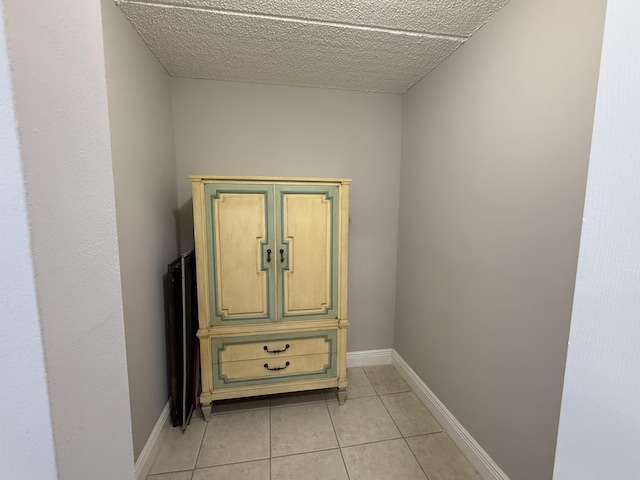 room details featuring baseboards and a textured ceiling