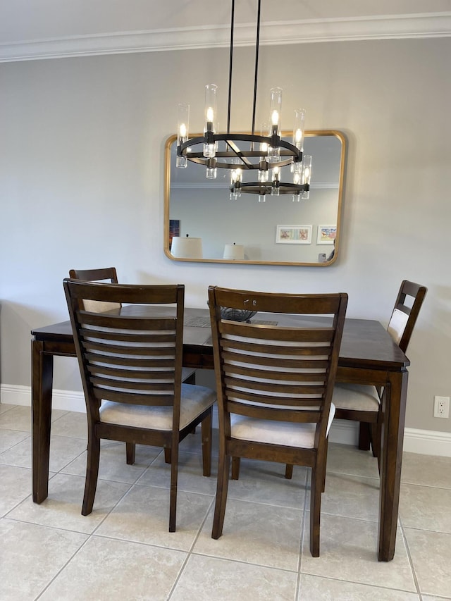 tiled dining space with baseboards, ornamental molding, and a chandelier
