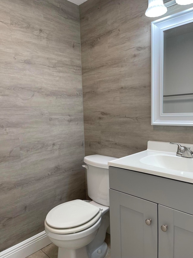 bathroom featuring vanity, tile patterned flooring, and toilet