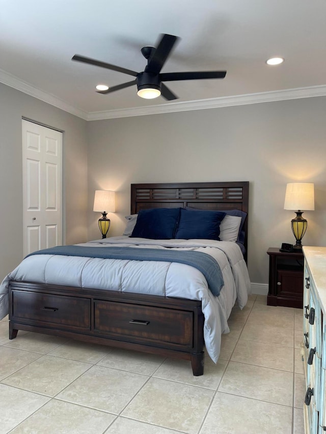 bedroom featuring ceiling fan, light tile patterned flooring, a closet, and crown molding