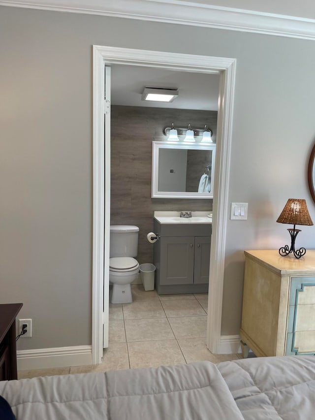 bathroom with vanity, crown molding, toilet, and tile patterned floors