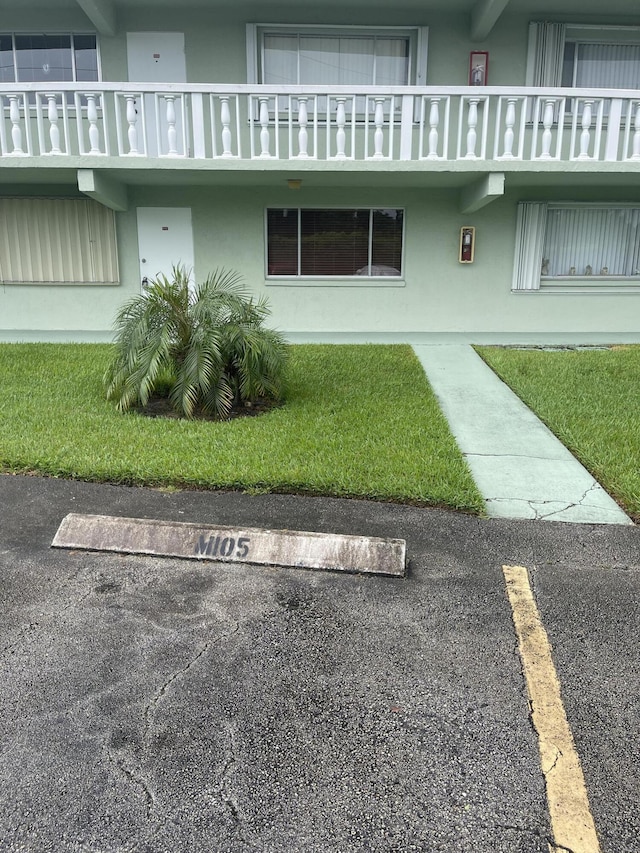 view of property featuring uncovered parking