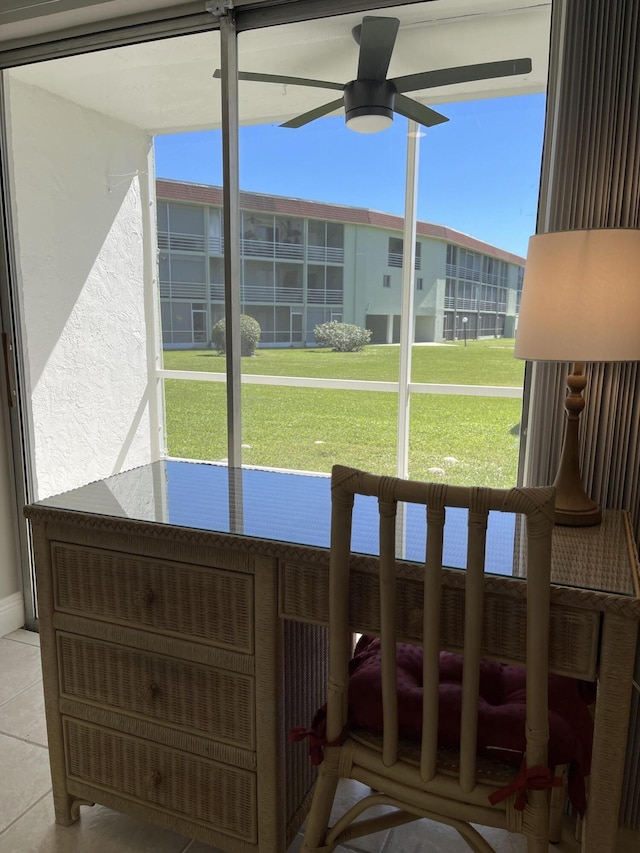 sunroom / solarium with a ceiling fan