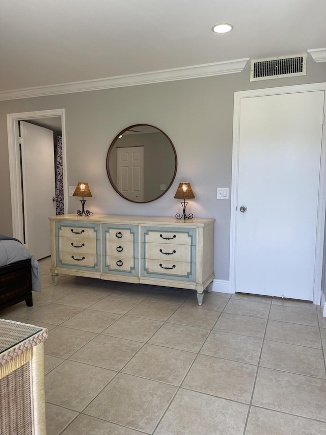 corridor with crown molding, light tile patterned flooring, baseboards, and visible vents
