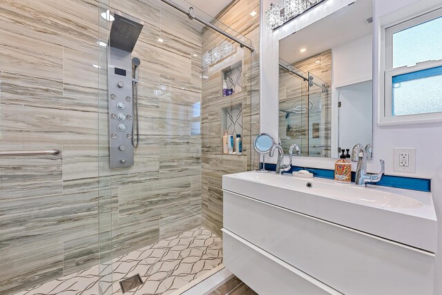 bathroom featuring vanity and an enclosed shower