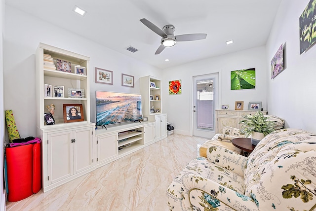 living room with ceiling fan and built in features