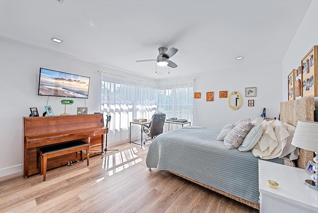 bedroom with light hardwood / wood-style floors and ceiling fan