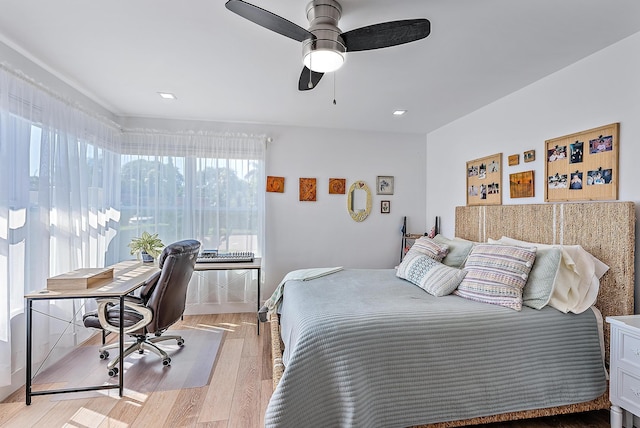 bedroom with ceiling fan and light hardwood / wood-style flooring