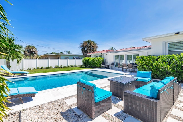 view of pool with an outdoor living space and a patio area