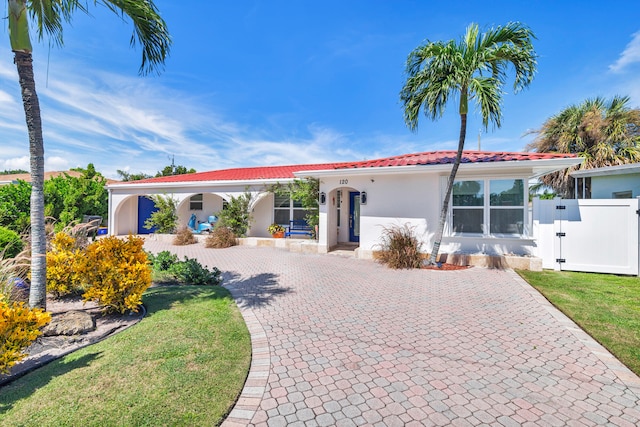 mediterranean / spanish-style house featuring a front lawn