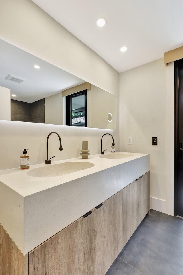 11880 Pebblewood Dr, Wellington, FL 33414 - bathroom featuring concrete floors, double vanity, and recessed lighting