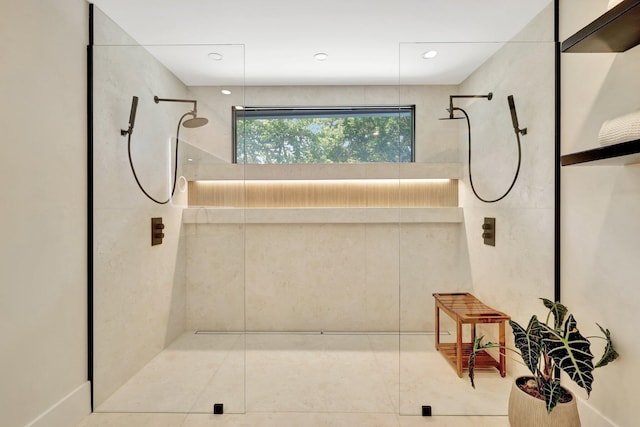 bathroom with tiled shower and tile patterned flooring