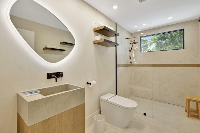 bathroom with toilet and a tile shower