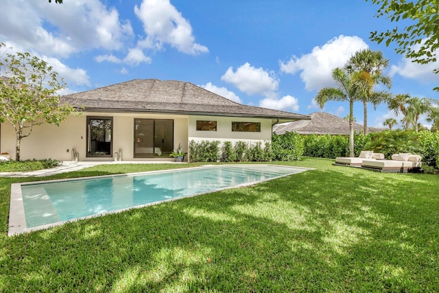 view of pool featuring a lawn and a patio area