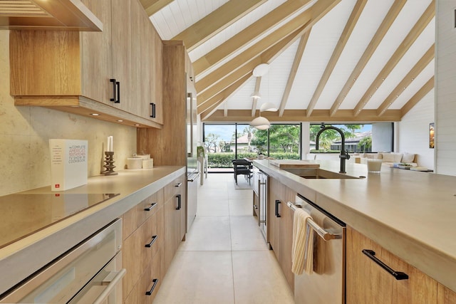 kitchen with lofted ceiling with beams, dishwasher, sink, wall chimney exhaust hood, and light brown cabinetry