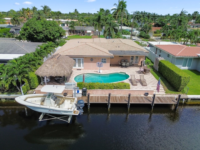 back of house with a patio, a water view, and a fenced in pool