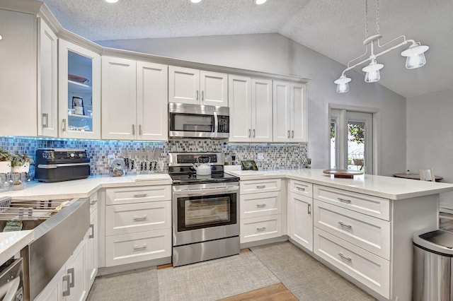 kitchen featuring white cabinetry, a textured ceiling, and appliances with stainless steel finishes