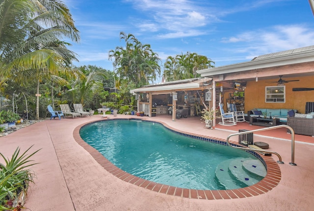 view of swimming pool featuring outdoor lounge area, ceiling fan, and a patio area