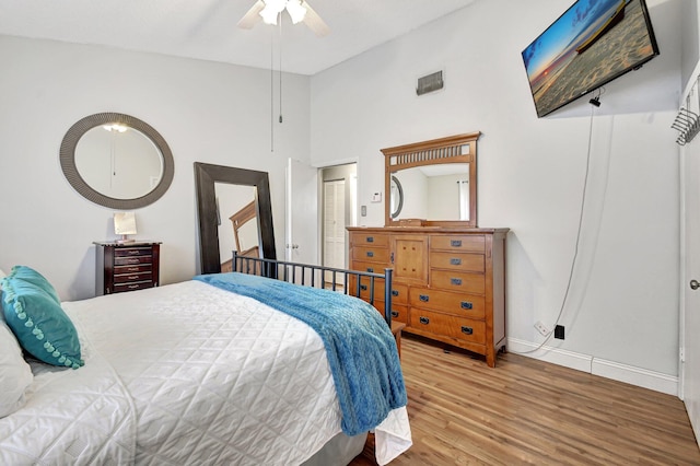 bedroom featuring high vaulted ceiling, light hardwood / wood-style flooring, and ceiling fan