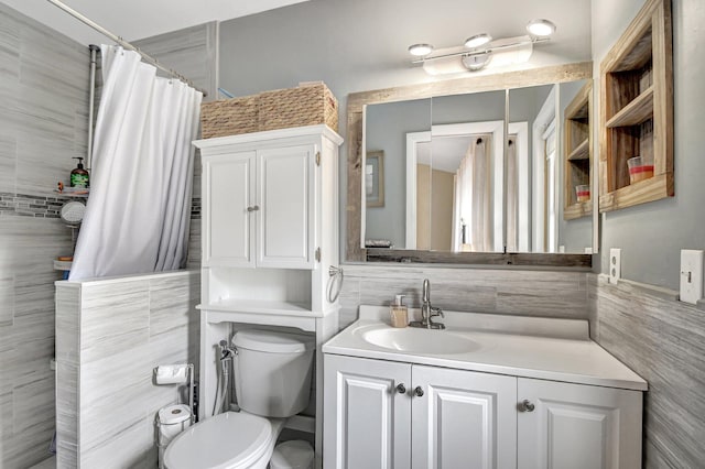 bathroom featuring vanity, toilet, tile walls, and curtained shower