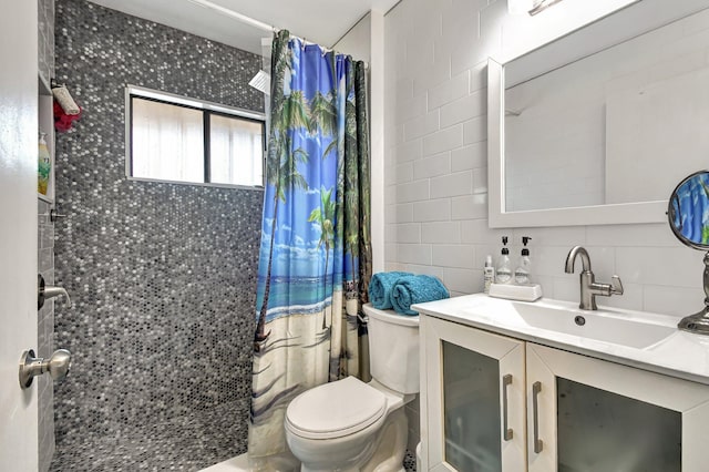 bathroom with vanity, backsplash, a shower with shower curtain, toilet, and tile walls