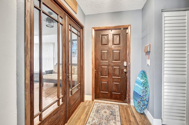 entrance foyer featuring light hardwood / wood-style flooring and a textured ceiling