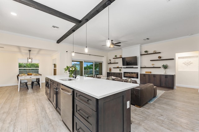 kitchen featuring dark brown cabinets, a center island with sink, light hardwood / wood-style floors, and sink