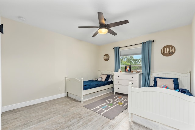 bedroom with light hardwood / wood-style flooring and ceiling fan