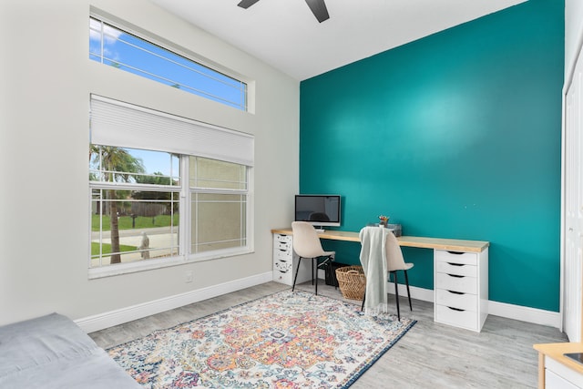 home office with ceiling fan and hardwood / wood-style floors