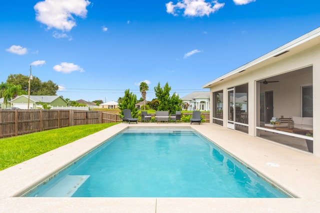 view of swimming pool featuring a patio and ceiling fan